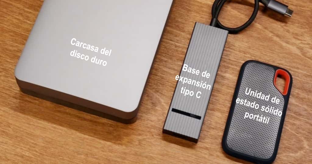 Tres dispositivos externos para ampliar el espacio de almacenamiento de la MacBook Air colocados sobre un escritorio de madera
