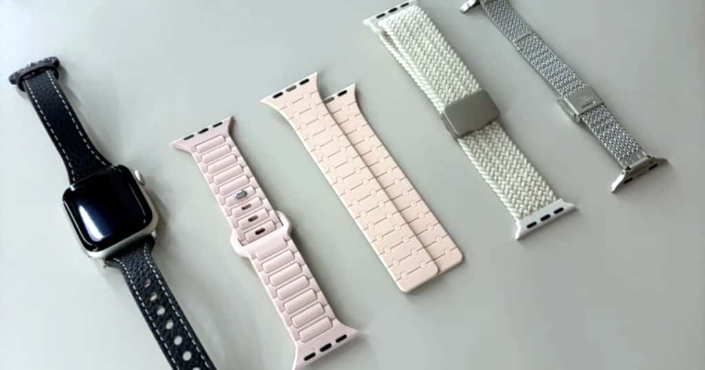 Öt különböző Apple Watch szíjanyag és stílus – többek között bőr, szilikon, szőtt nejlon és rozsdamentes acél háló – egymás mellett bemutatva a 44 mm-es Apple Watch szíjtípusok és anyagok