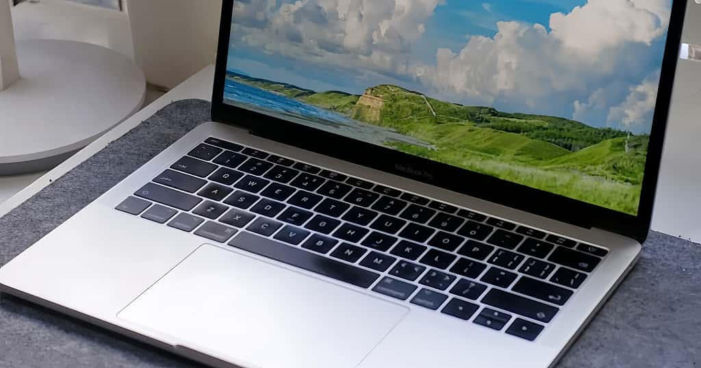 MacBook dengan layar menyala, menonjolkan keunggulan MacBook dalam desain elegan, performa bertenaga, dan pengalaman visual