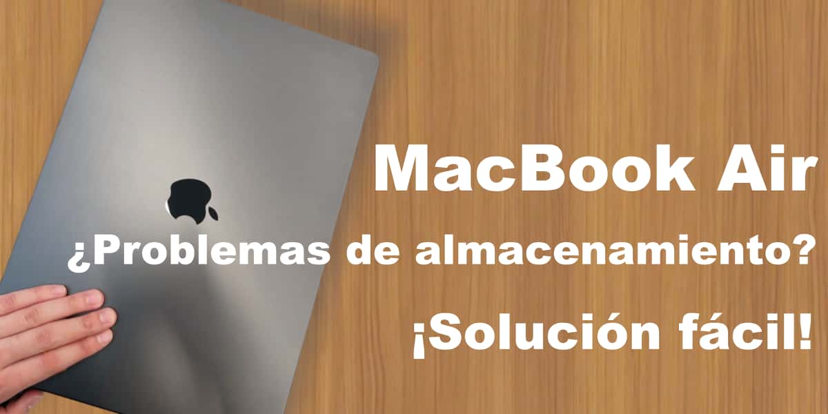 Imagen de una persona sosteniendo una MacBook Air sobre una mesa de madera, sobre cómo solucionar problemas de almacenamiento de la MacBook Air